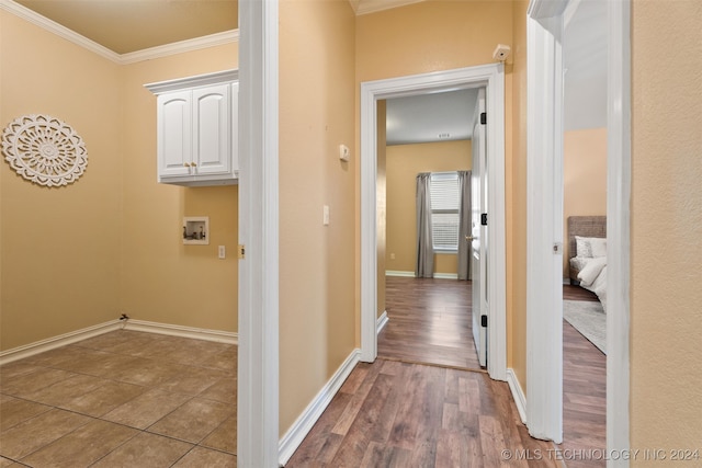 laundry area featuring hookup for a washing machine, hardwood / wood-style floors, cabinets, and ornamental molding