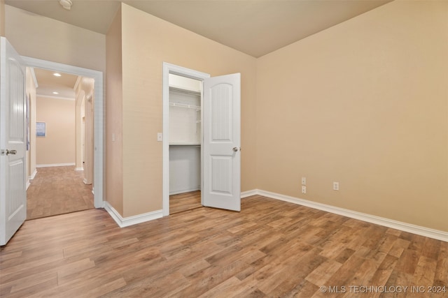 unfurnished bedroom featuring a closet and light hardwood / wood-style flooring