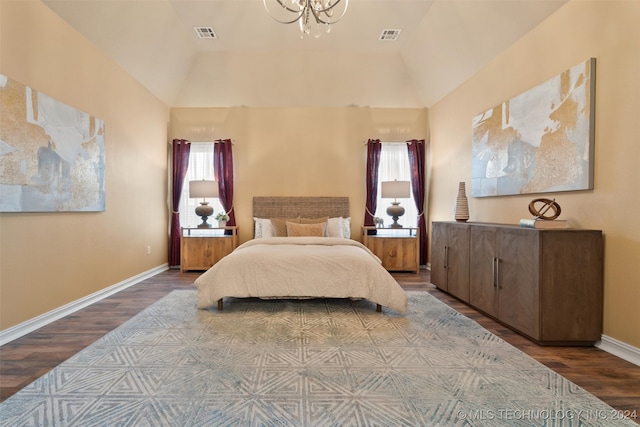 bedroom featuring multiple windows, vaulted ceiling, and hardwood / wood-style flooring