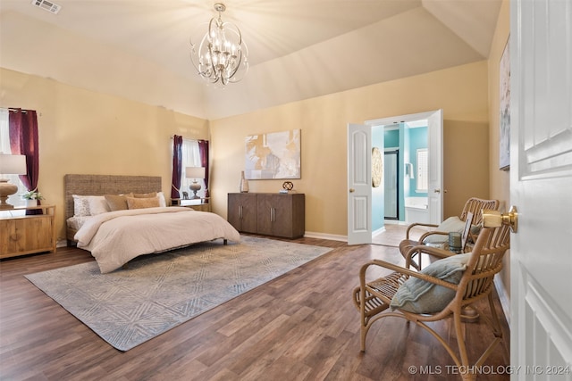 bedroom with a notable chandelier, ensuite bathroom, hardwood / wood-style floors, vaulted ceiling, and multiple windows