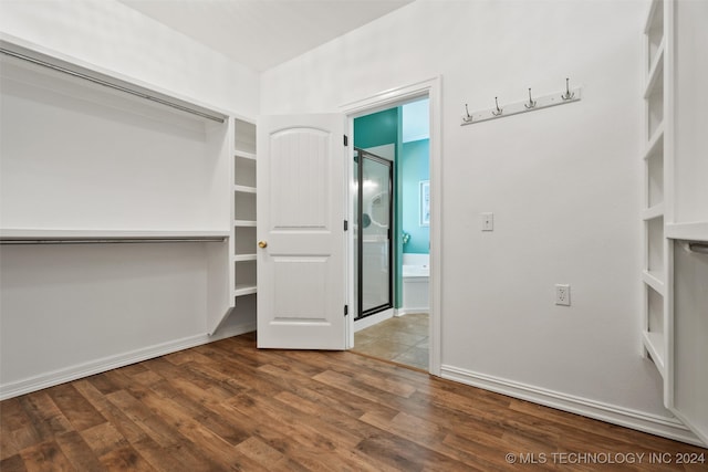 walk in closet with wood-type flooring