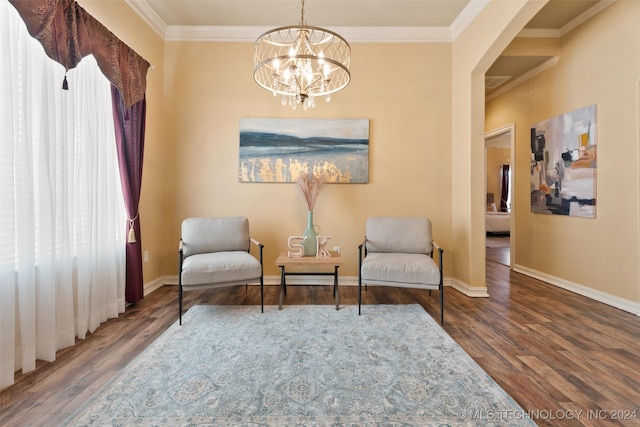 living area featuring crown molding, a chandelier, and hardwood / wood-style flooring