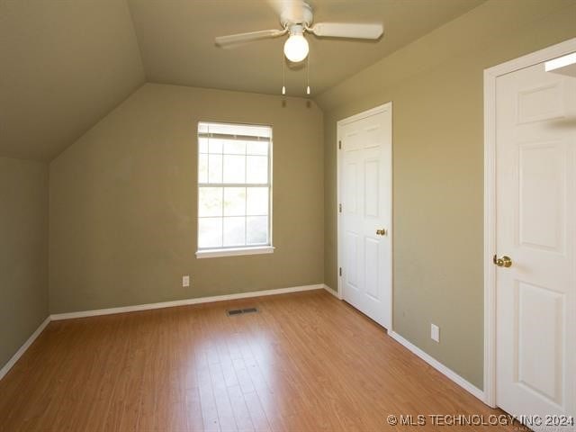 additional living space with ceiling fan, lofted ceiling, and light hardwood / wood-style flooring