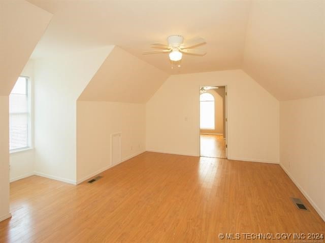 additional living space featuring plenty of natural light, light hardwood / wood-style floors, and ceiling fan