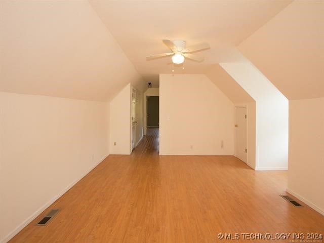 bonus room featuring light hardwood / wood-style floors, ceiling fan, and lofted ceiling