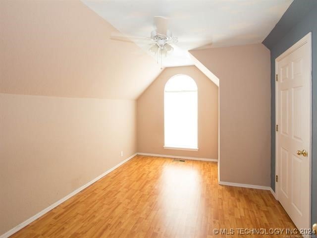 additional living space featuring ceiling fan, lofted ceiling, and light hardwood / wood-style flooring