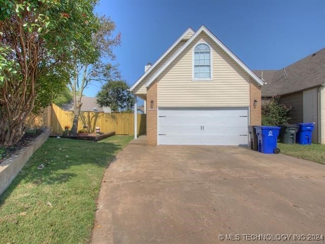 1132 W Florence Ct, Broken Arrow, OK 74011 - view of front of house with a garage, brick siding, driveway, and a chimney