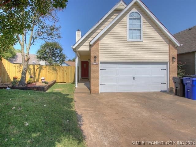 1132 W Florence Ct, Broken Arrow, OK 74011 - traditional-style house featuring brick siding, a chimney, and driveway