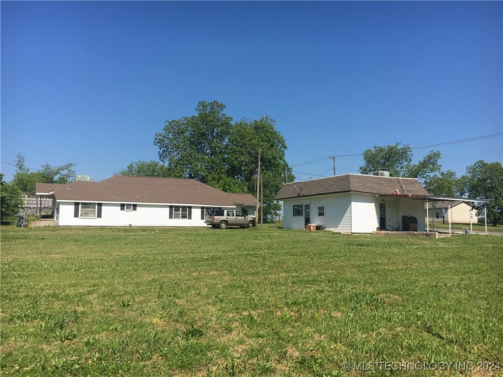 rear view of property with a yard