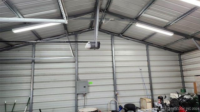 garage with a garage door opener and electric panel