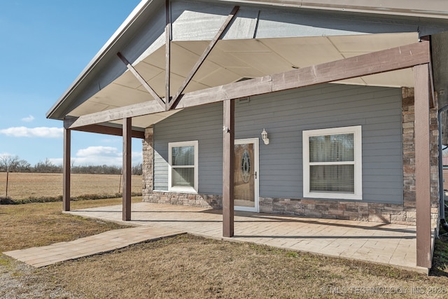 rear view of house featuring a yard and a patio