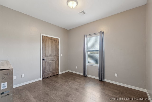 empty room featuring dark hardwood / wood-style floors