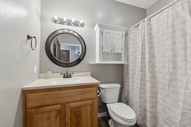 bathroom featuring vanity and toilet