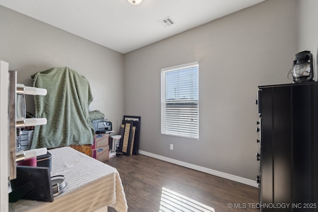 bedroom with dark wood-type flooring