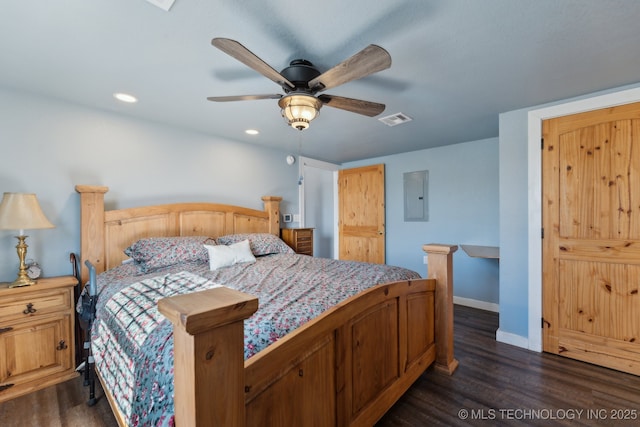 bedroom featuring ceiling fan, dark hardwood / wood-style flooring, and electric panel