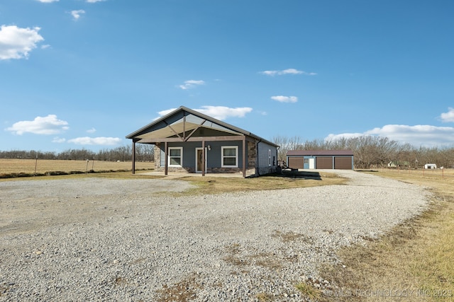 view of front of home with an outbuilding, a garage, and covered porch