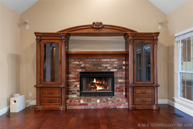 interior space featuring wood-type flooring and a brick fireplace