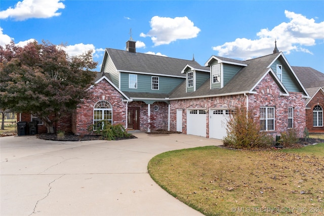 view of property featuring a front yard and a garage