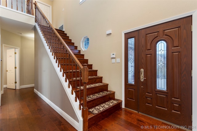 foyer entrance with dark wood-type flooring