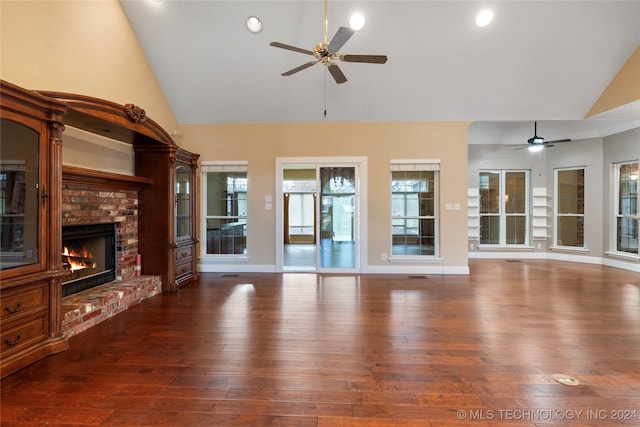 unfurnished living room featuring ceiling fan, high vaulted ceiling, dark hardwood / wood-style floors, and a brick fireplace