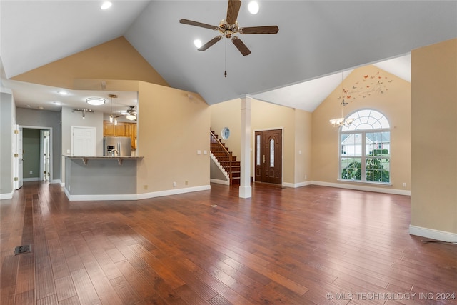 unfurnished living room featuring dark hardwood / wood-style flooring, high vaulted ceiling, and ceiling fan with notable chandelier