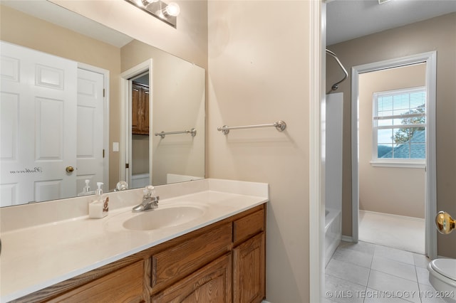 full bathroom featuring tile patterned floors, vanity, shower / bath combination, and toilet