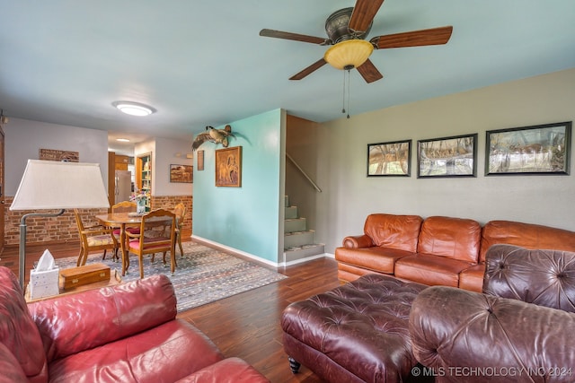 living room featuring dark hardwood / wood-style floors and ceiling fan