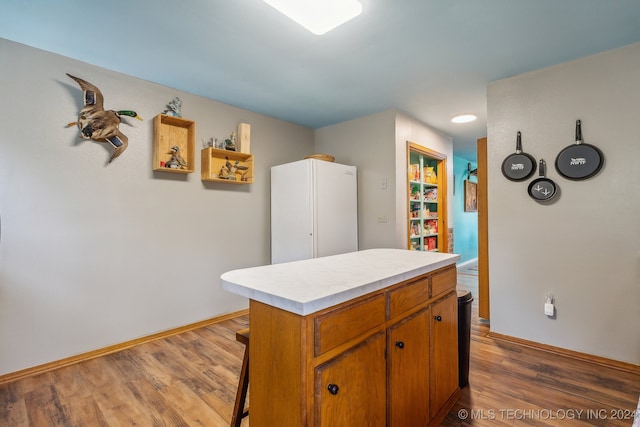 kitchen with a kitchen island and dark hardwood / wood-style flooring