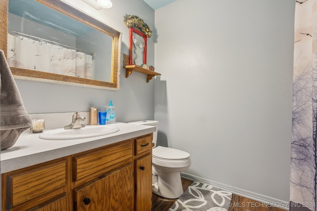 bathroom featuring hardwood / wood-style floors, vanity, and toilet