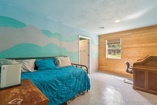 bedroom featuring wooden walls