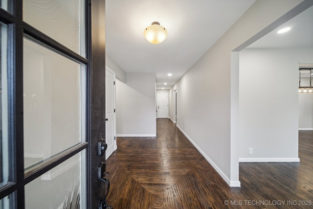 hall featuring recessed lighting, baseboards, and wood finished floors