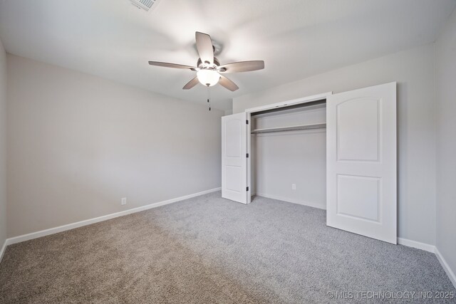 unfurnished bedroom featuring carpet, ceiling fan, and a closet