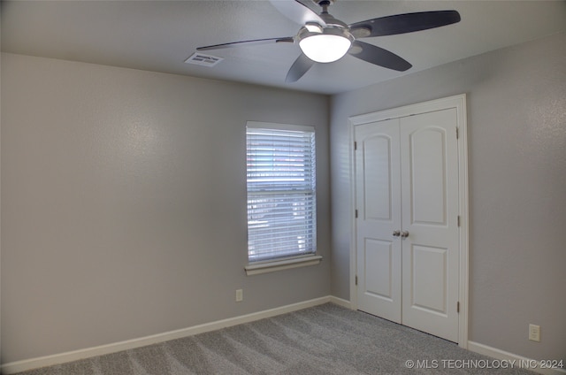 unfurnished bedroom with light carpet, a closet, and ceiling fan