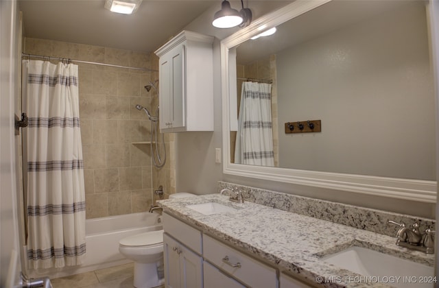 full bathroom with tile patterned flooring, shower / bath combination with curtain, toilet, and vanity