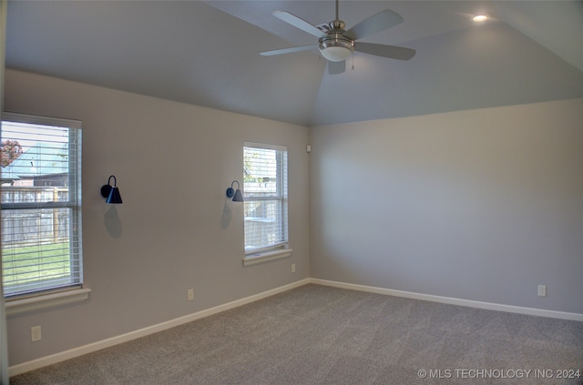 carpeted empty room with ceiling fan and lofted ceiling