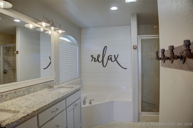 bathroom featuring vanity, tile patterned flooring, and plus walk in shower