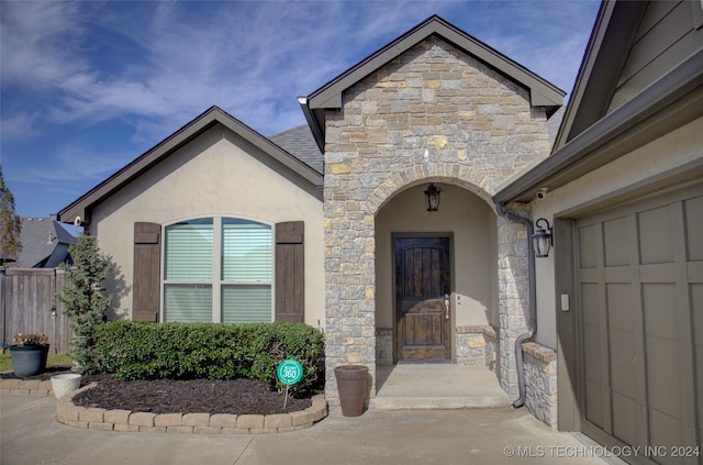 doorway to property with a garage