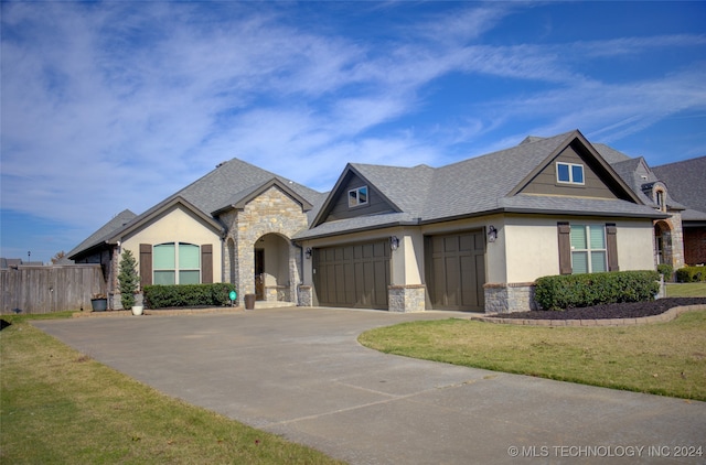 view of front facade featuring a garage and a front lawn