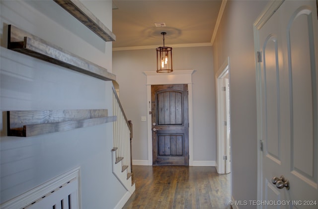 entrance foyer with dark hardwood / wood-style flooring and ornamental molding