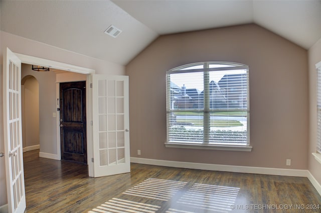 unfurnished room with french doors, dark hardwood / wood-style floors, and vaulted ceiling