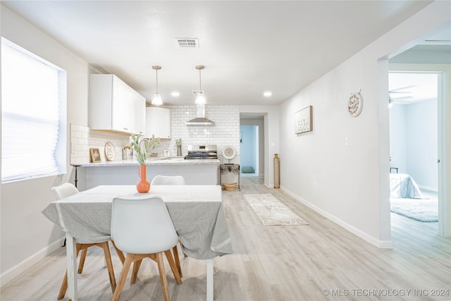 dining space featuring light hardwood / wood-style flooring and ceiling fan