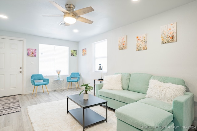 living room with ceiling fan and light hardwood / wood-style floors