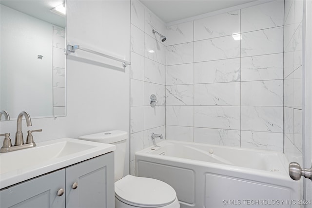 full bathroom with vanity, toilet, and tiled shower / bath