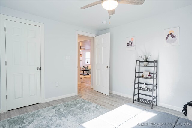 unfurnished bedroom featuring light hardwood / wood-style flooring and ceiling fan