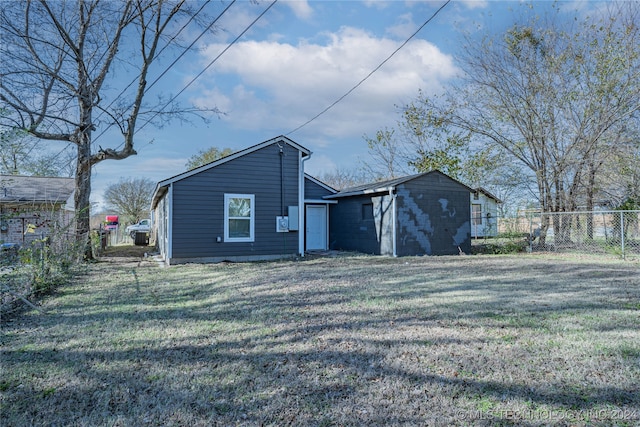 rear view of property with a yard