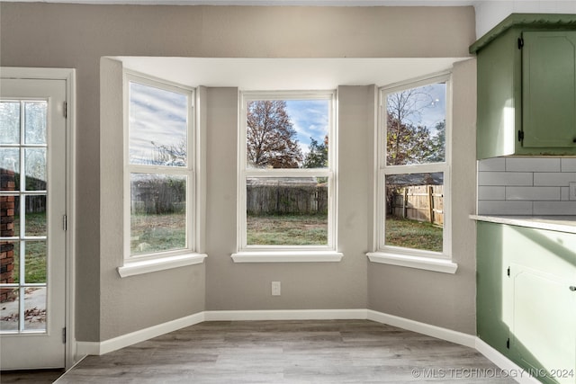 unfurnished dining area with light wood-type flooring