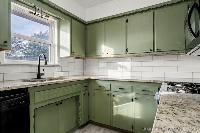 kitchen with sink, backsplash, green cabinets, and black appliances