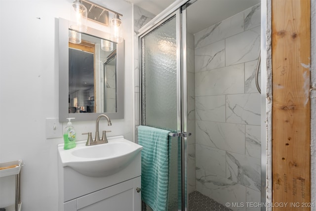 bathroom with vanity and a shower with shower door