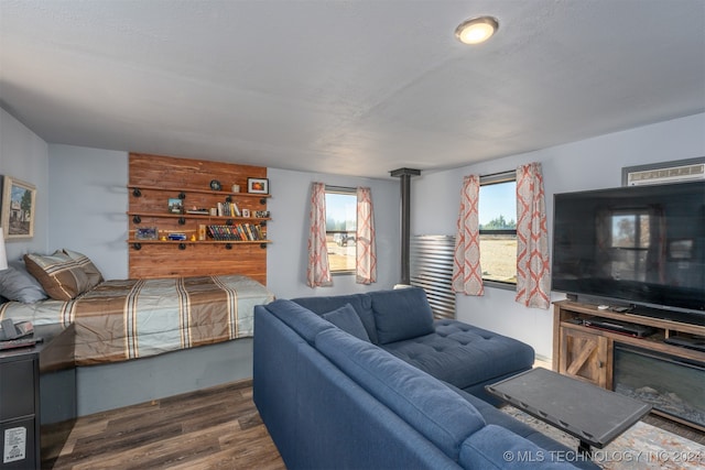 bedroom featuring multiple windows and dark hardwood / wood-style floors