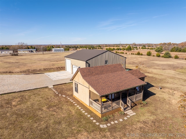 birds eye view of property with a rural view